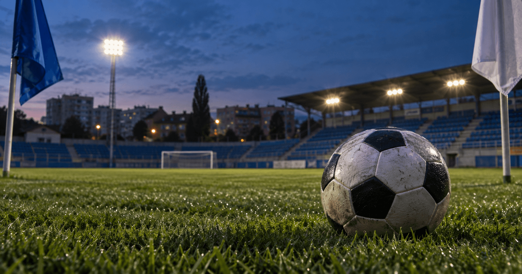 AI-generated illustration of a football on a floodlit pitch with blue seats at dusk